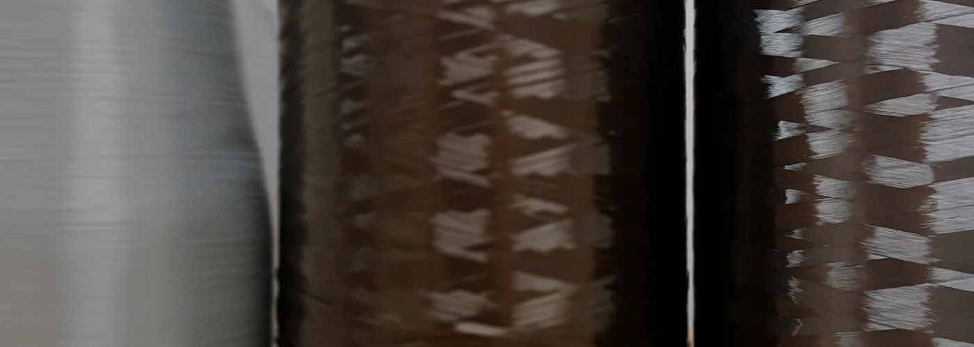 a mixture of natural and synthetic fibre spools in different colours